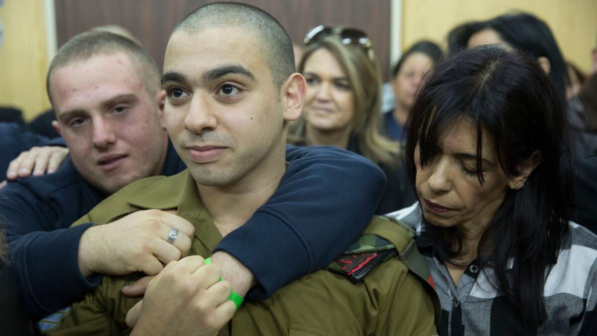 Israel Defense Forces Sgt. Elor Azaria with his parents in military court in Tel Aviv on Jan. 4, 2017.