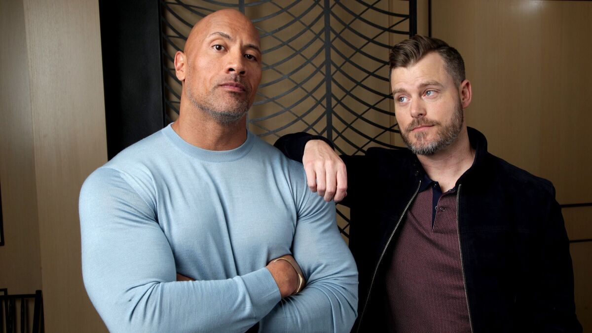Star Dwayne Johnson, left, and writer-director Rawson Marshall Thurber of "Skyscraper," the only major studio release in July that is not part of an existing franchise.