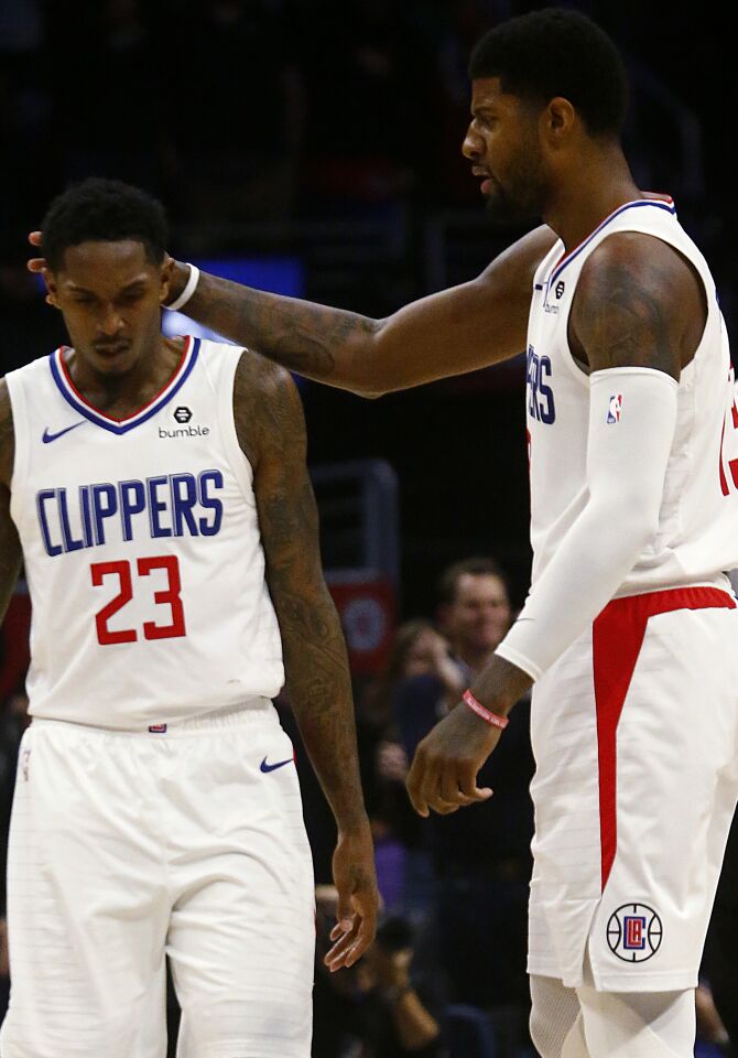 Clippers guard Lou Williams is congratulated by Paul George after hitting a three-pointer against the Celtics during the fourth quarter of a game Nov. 20 at Staples Center.
