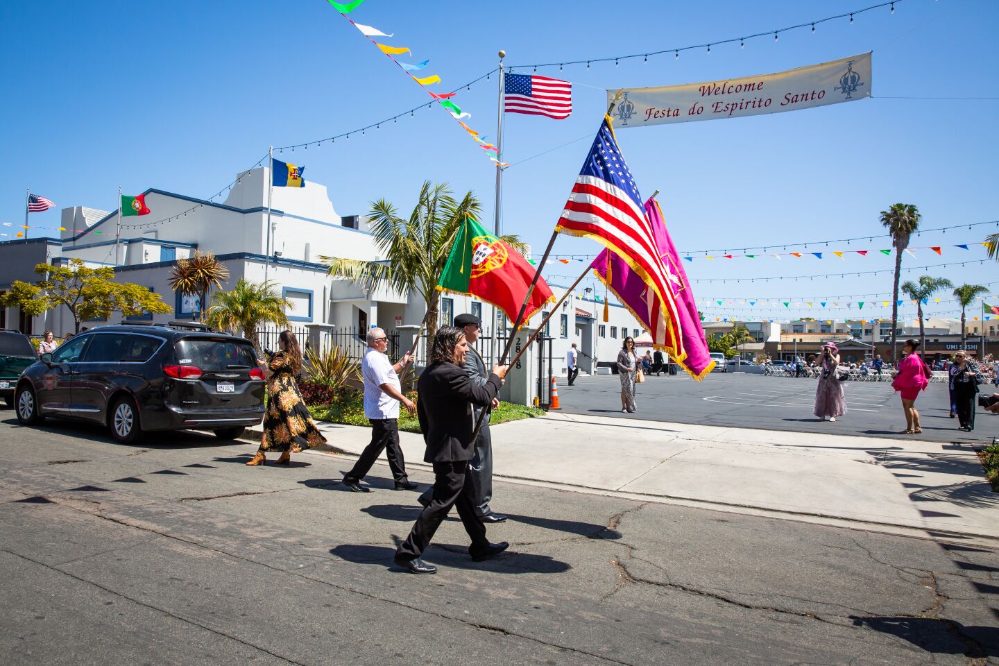 Jerry Balelo (foreground), Jose Virissimo (center) and Manuel Virissimo carry the flags for the Festa do Espirito Santo (Feast of the Holy Spirit) ceremonies May 23.