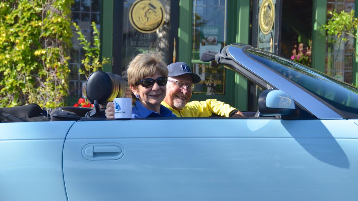 Commodore Marie Case Cruising for Coffee with former Commodore Skipper Tom Johnson driving his convertible T-Bird.