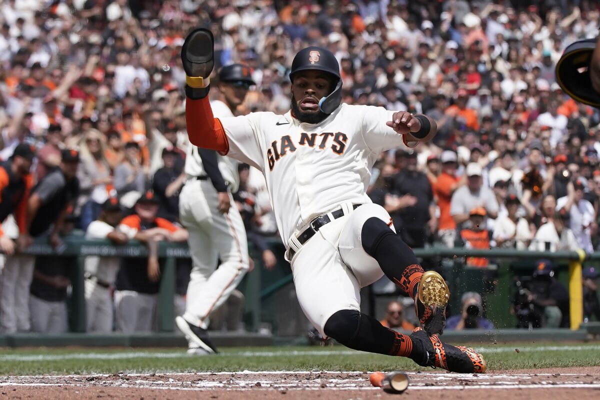 San Francisco Giants' Heliot Ramos slides home to score during the second inning of a baseball game against the Miami Marlins, in San Francisco, Sunday, April 10, 2022. (AP Photo/Jeff Chiu)