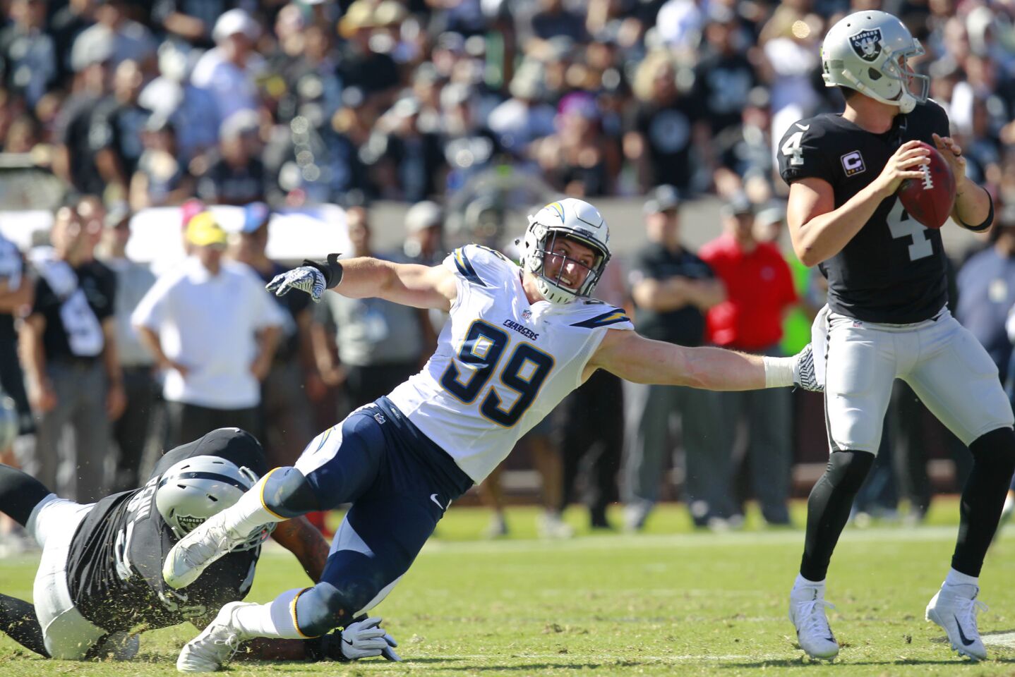 San Diego Chargers Joey Bosa tries to sack Oakland Raiders quarterback Derek Carr in the 2nd quarter in Oakland on Oct. 9, 2016. (Photo by K.C. Alfred/The San Diego Union-Tribune)