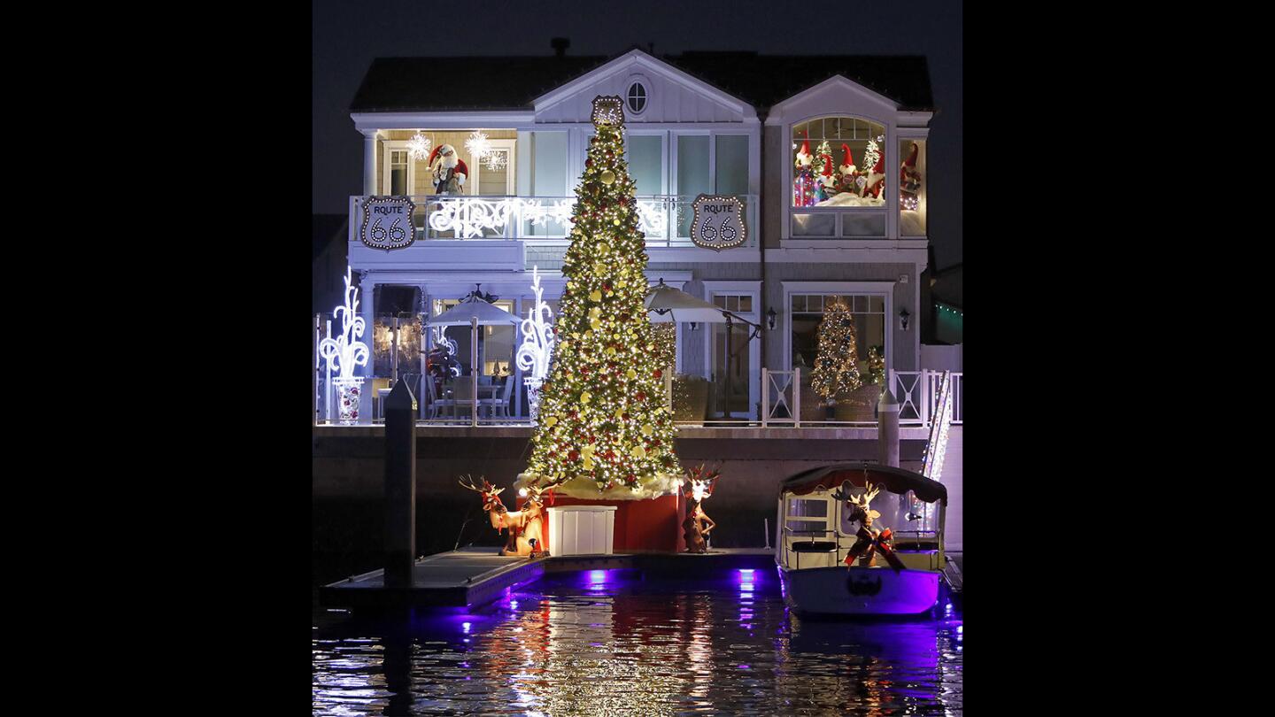 A home decorated with a large Christmas tree during the annual Huntington Harbour Cruise of Lights on Saturday.
