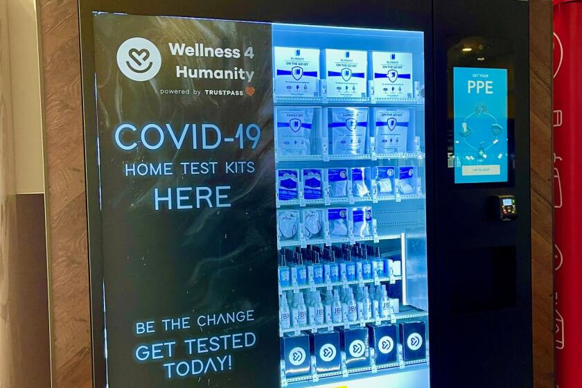 A vending machine in the Oakland International Airport sells PPE kits, masks, sanitizer, and COVID test kits. 