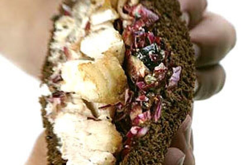 SANDWICH TWIST: Cod is pan fried and then topped with slaw and tucked in between pumpernickel bread.