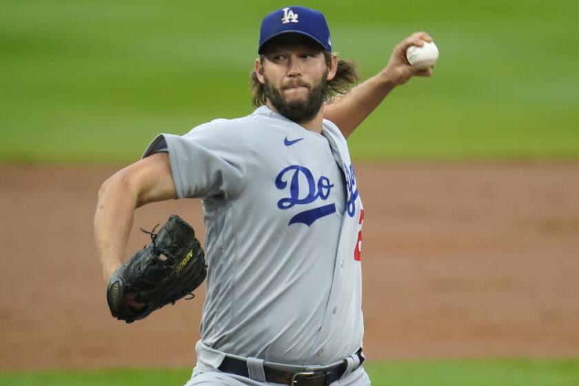 Los Angeles Dodgers starting pitcher Clayton Kershaw works against the Colorado Rockies.