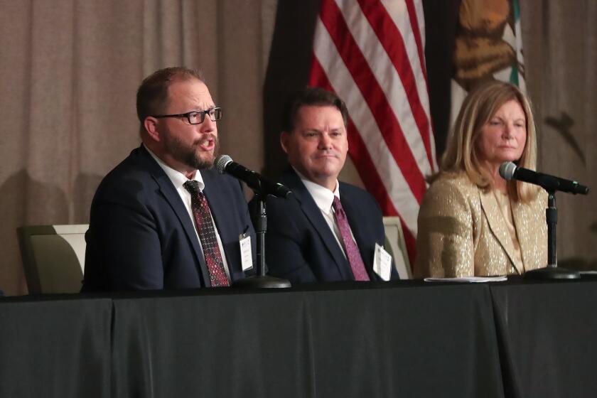 Public Works Director Mark McAvoy, acting City Manager Gavin Curran, and Mayor Sue Kemph, from left, answer public questions on a panel, during the Laguna Beach State of the City address at the Montage on Tuesday.