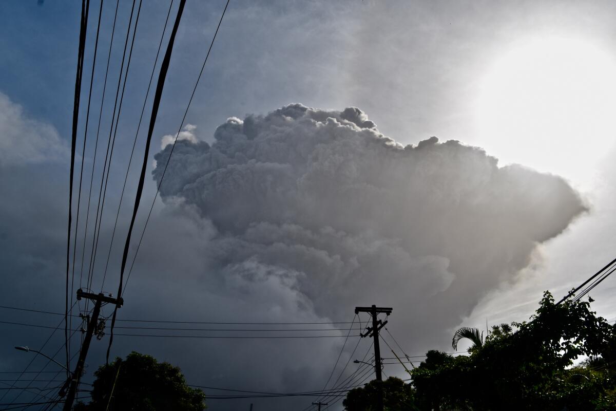 Ash rises into the air as La Soufriere volcano erupts on the eastern Caribbean island of St. Vincent, seen from Chateaubelair, Friday, April 9, 2021. (AP Photo/Orvil Samuel)
