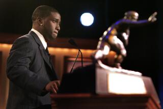 USC tailback back Reggie Bush pauses while delivering his Heisman Trophy acceptance speech in 2005