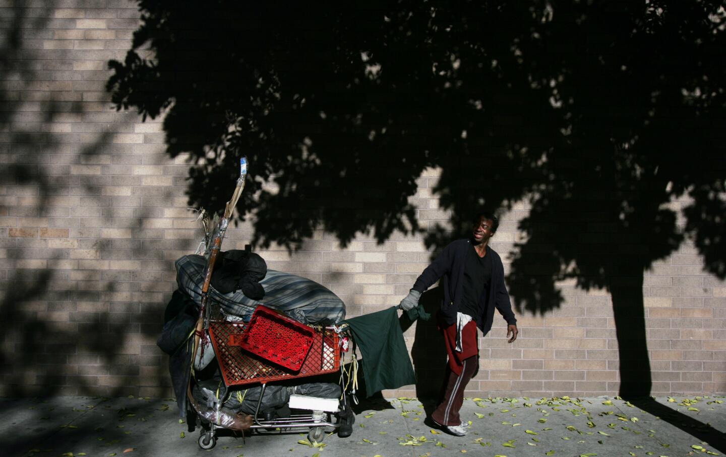 JOURNEY: Nathaniel drags his cart through skid row to store briefly while he goes to the hall.