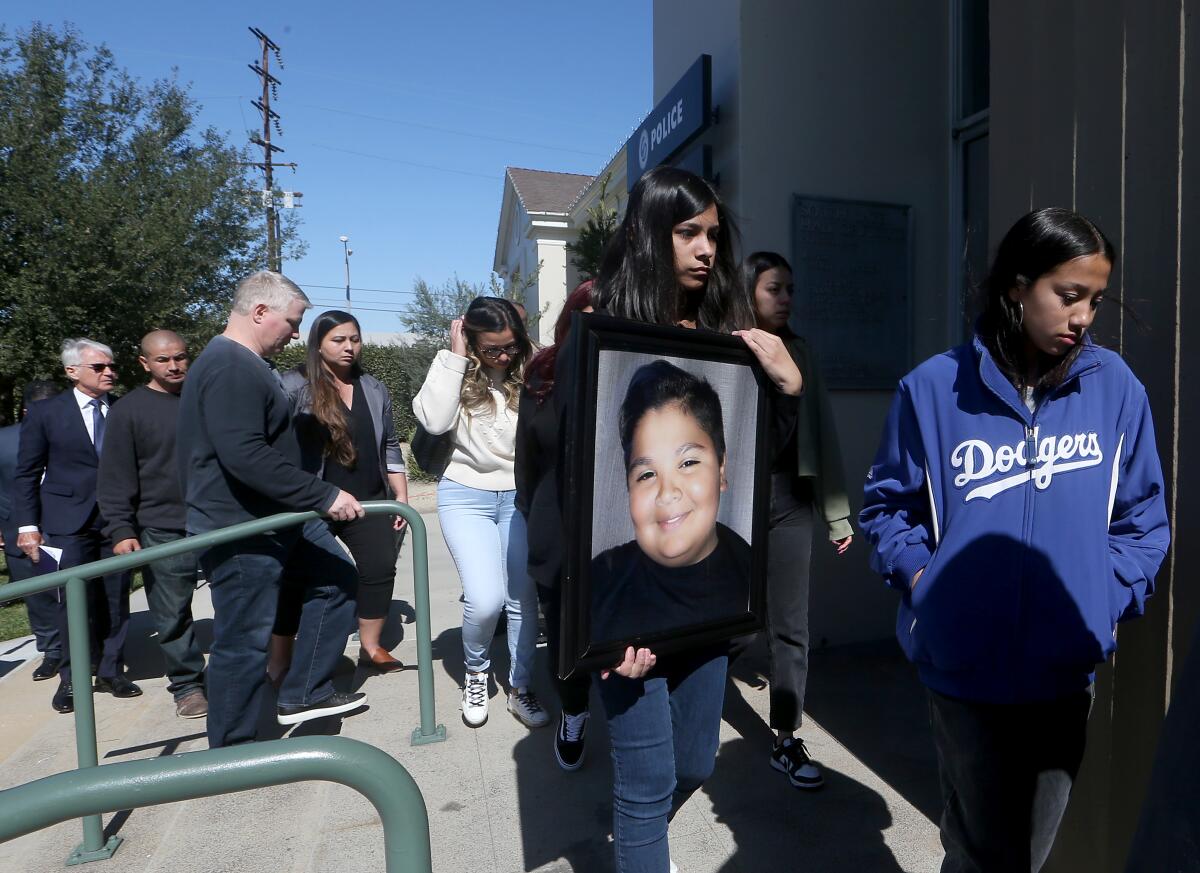 Family members carry a picture of Isaiah Rodriguez