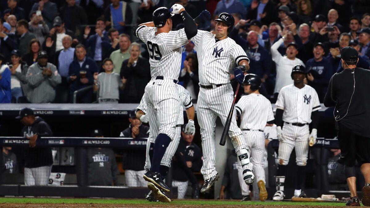 Yankees' Aaron Judge (99) celebrates with teammate Gary Sanchez (24) after hitting a two-run home run against the Minnesota Twins during the fourth inning in the American League Wild Card Game at Yankee Stadium on Oct. 3.
