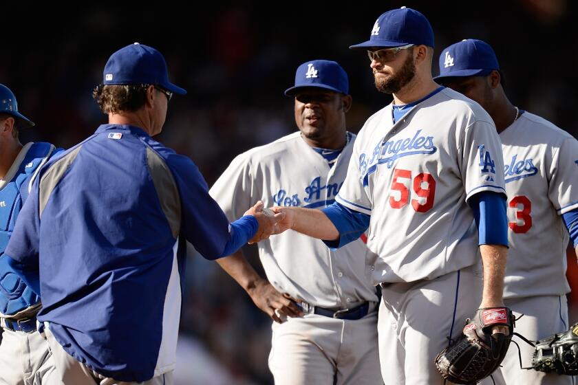 Dodgers starting pitcher Stephen Fife is pulled from the game by Manager Don Mattingly, left, in the fifth inning of Saturday's 4-2 loss to the San Francisco Giants.
