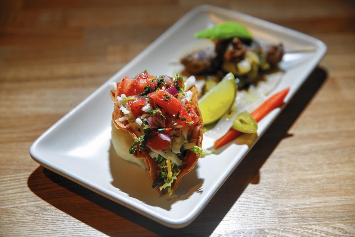 Surf and turf tacos -- one with lobster, the other with filet mignon -- are on the menu at Maradentro.