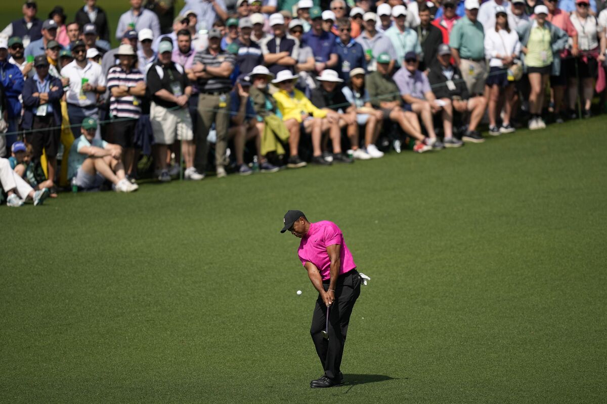 Tiger Woods chips to the second green during the first round at the Masters golf tournament in Augusta, Ga.
