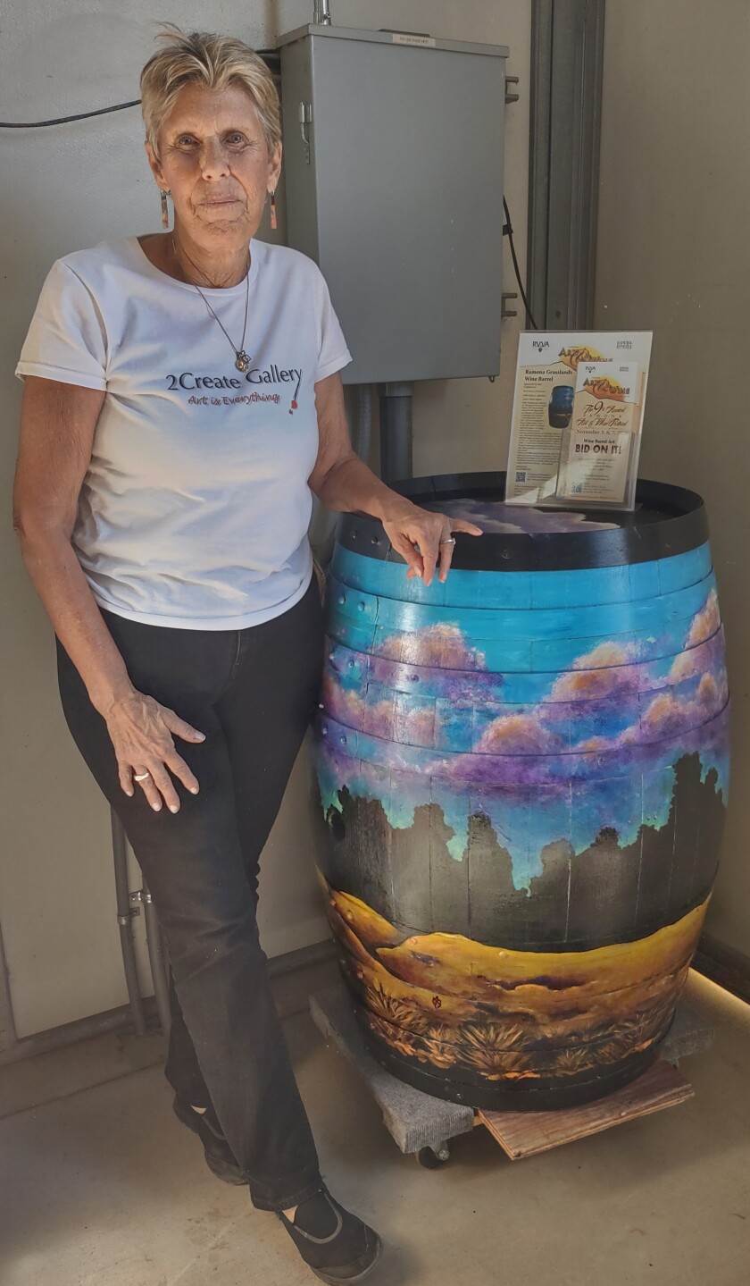 Molly Begent shows off her barrel of Ramona Grasslands wine which was auctioned for $ 625 at Old Julian Vineyards & Winery.
