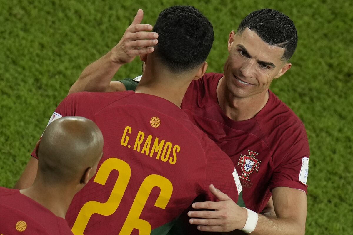 Portugal's Cristiano Ronaldo embraces team mate Goncalo Ramos during his substitution at the World Cup group H soccer match between Portugal and Ghana, at the Stadium 974 in Doha, Qatar, Thursday, Nov. 24, 2022. (AP Photo/Francisco Seco)
