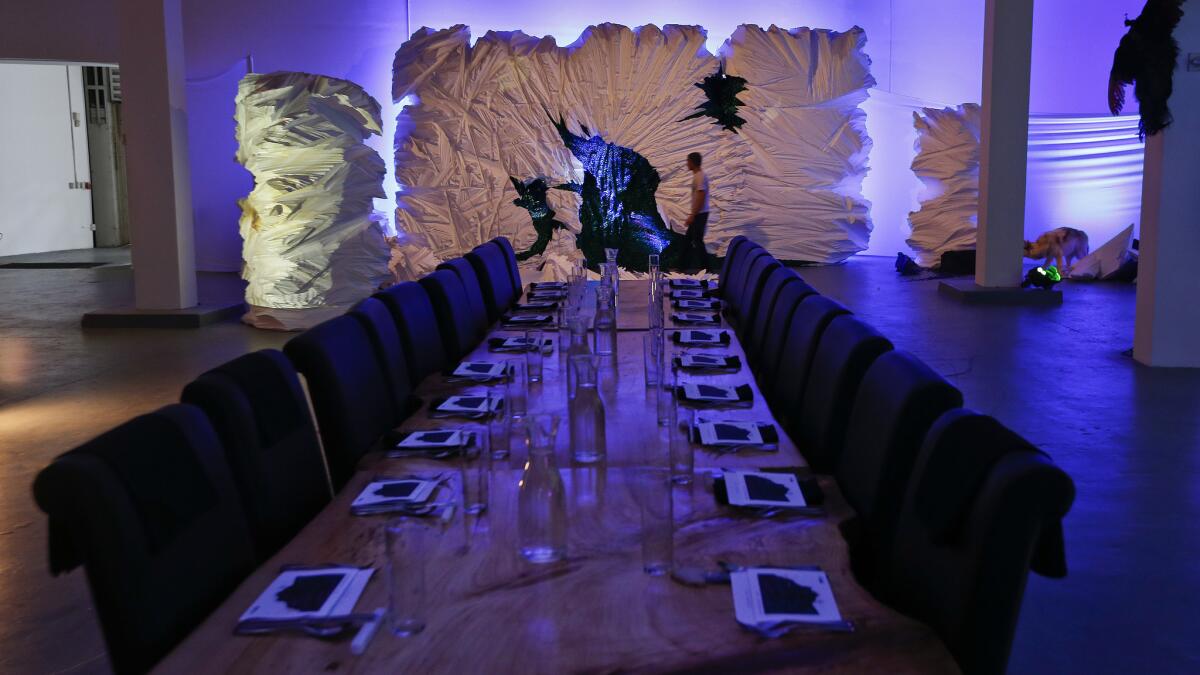Dinner is served at a long table amid an elaborately constructed set at MOCA's Little Tokyo location.