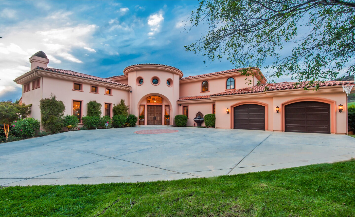 The 1.5-acre estate includes a 7,500-square-foot villa, pool house, swimming pool, spa, putting green and pavilion.