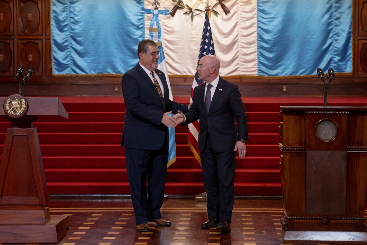 Guatemalan President Bernardo Arevalo shakes hands with U.S. Homeland Security Secretary Alejandro Mayorkas.