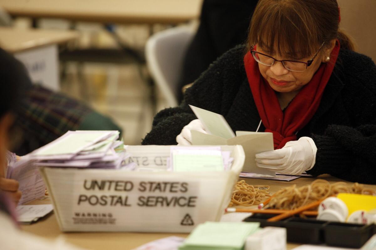 An inspector prepares ballots from the Los Angeles primary election to be counted at Piper Technical Center in Los Angeles on March 4.