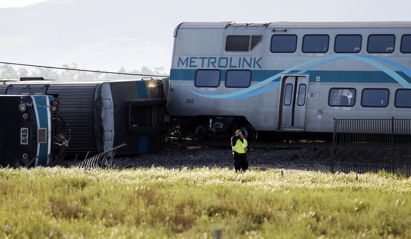 A Ventura County first responder at the scene of an overturned Metrolink train car in Oxnard after it colliding with a vehicle on the tracks.