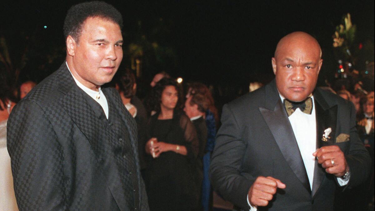 Muhammad Ali, left, and George Foreman arrive at the Vanity Fair Oscar party in Los Angeles on March 24, 1997.