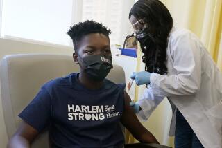 Julian Boyce, 14, receives his first Pfizer COVID-19 vaccination at NYC Health + Hospitals/Harlem.
