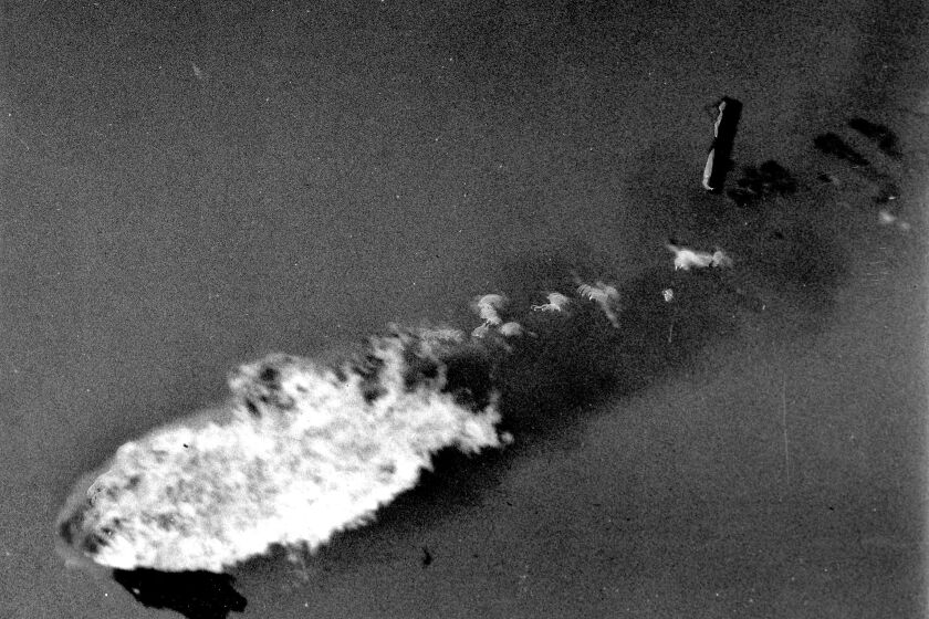 Convair Sea Dart explodes during high-speed pass over the bay in demonstration flight Nov. 4, 1954. As stricken plane plunges downward an engine falls clear, flames are swept forepart of fuselage. San Diego Union photo by Leslie A. Dodds.
