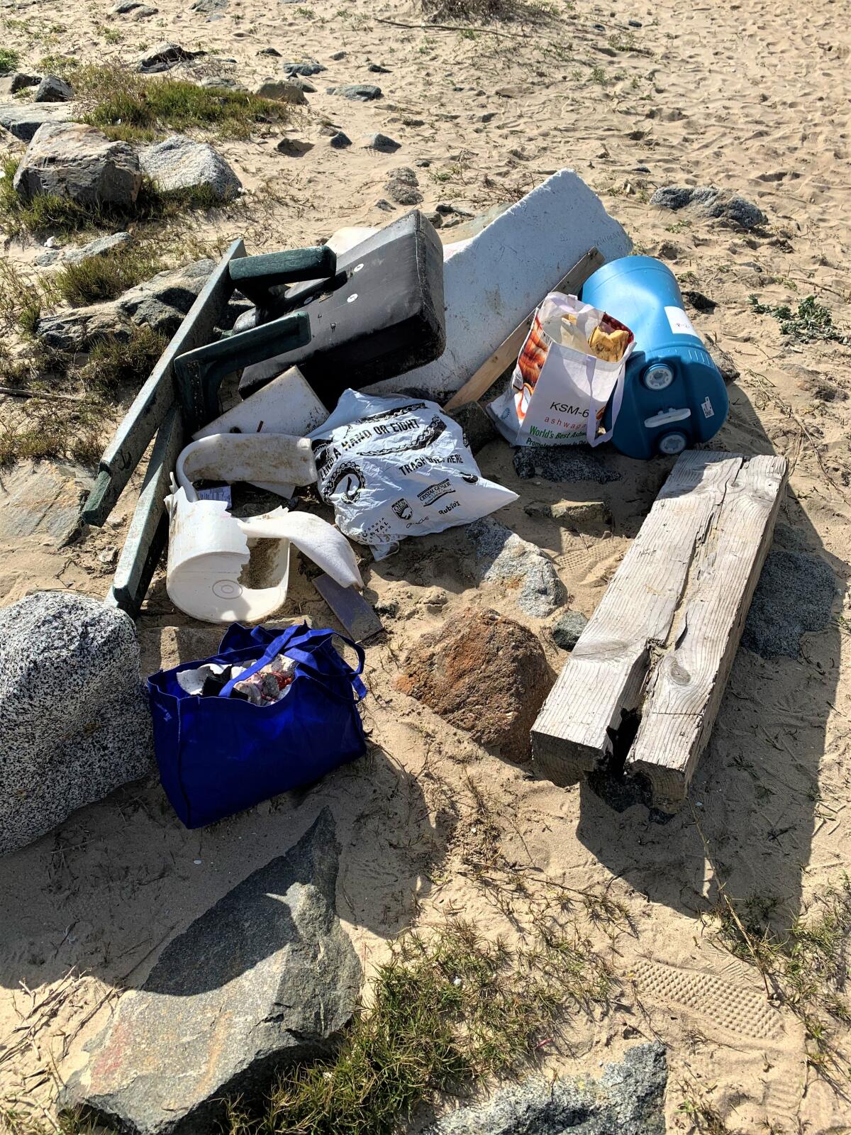 Items washed onto Huntington State Beach by recent storms were gathered Thursday by student volunteers with O.C. Coastkeeper.