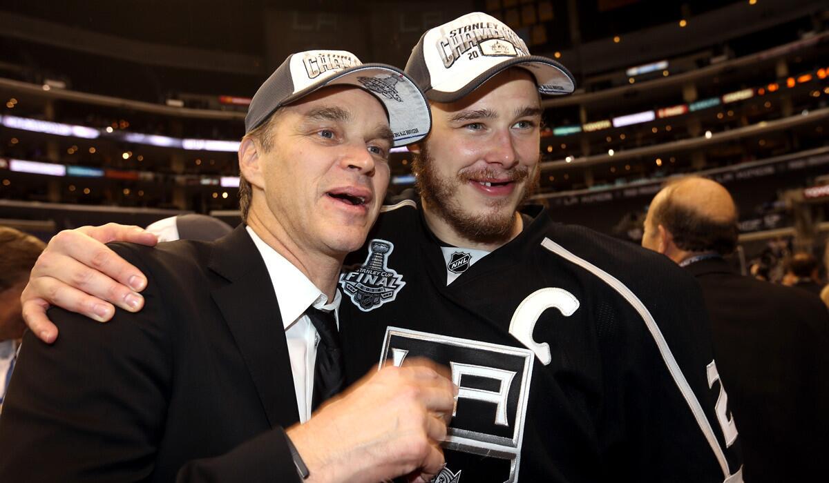Former Kings star Luc Robitaille, left, now the club's president of business operations, and captain Dustin Brown celebrate after the Kings clinched their second Stanley Cup championship in three seasons.
