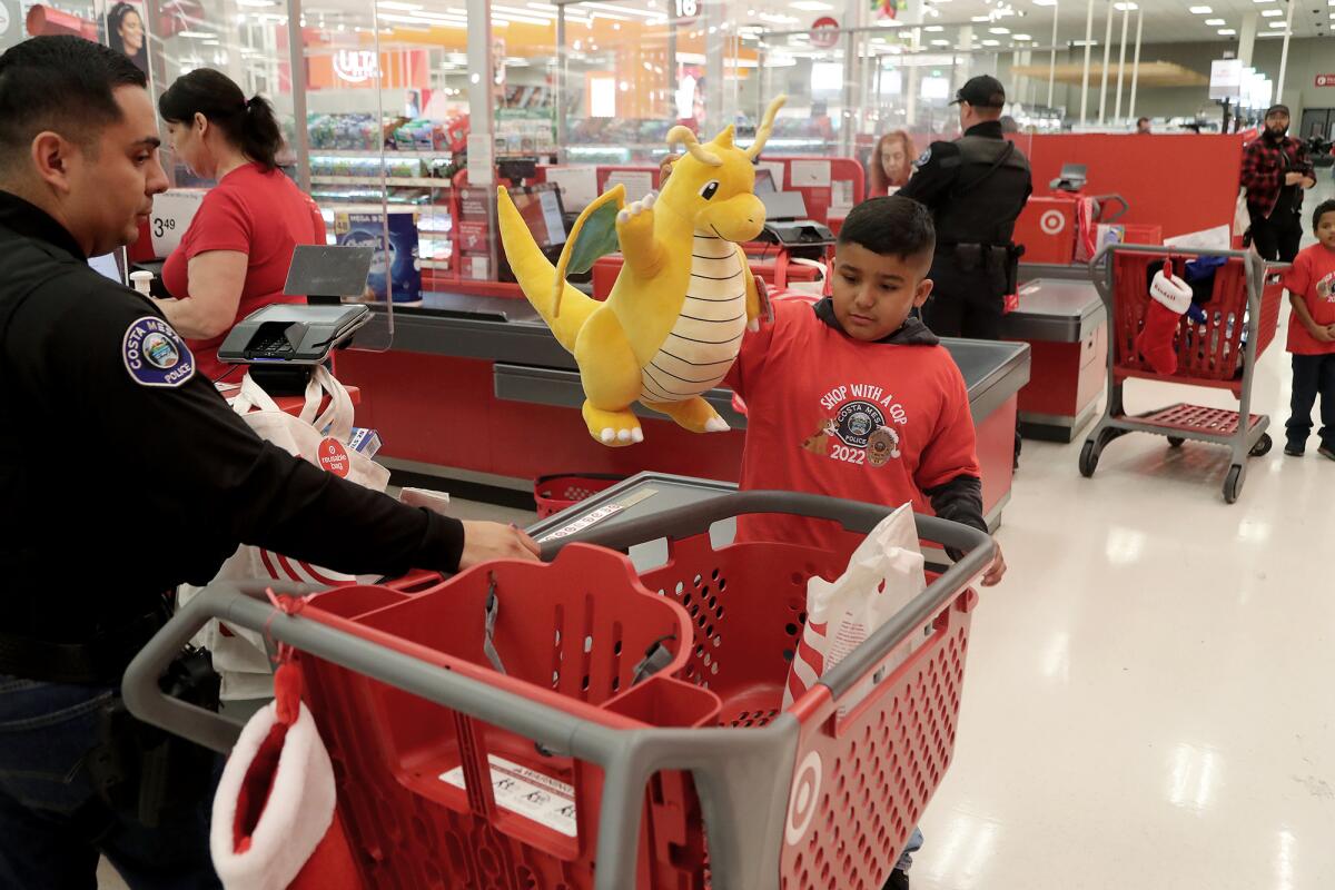 Frank Garcia, 9, collects a stuffed Pokemon during the Costa Mesa Police Department's Shop with a Cop event Wednesday.