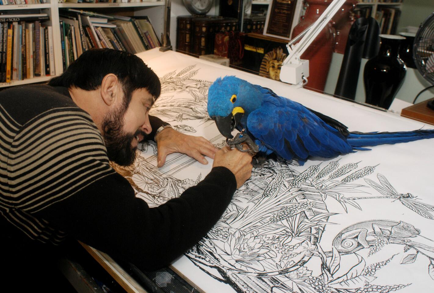 In this photo provided by Rain Bird, world-renowned float designer Raul Rodriguez puts the finishing touches on a Rose Parade float he designed in 2006.