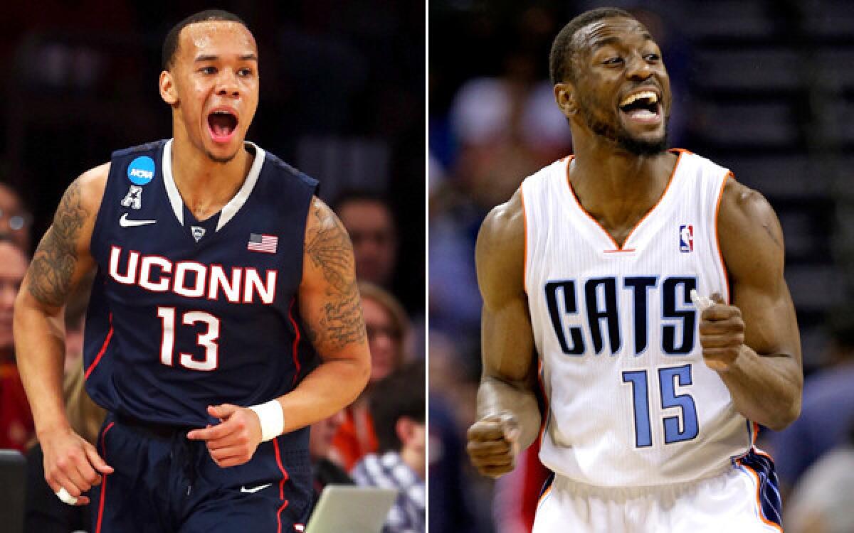 Connecticut point guard Shabazz Napier (13) is following in the footsteps of mentor Kemba Walker, a former UConn star and starter with the Charlotte Bobcats in the NBA.