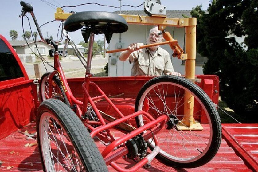 Doug Qua used a lift to unload his tricycle at his home Thursday. He thinks his tricycle is safer than wheelchairs, scooters and strollers that the zoo allows. (Eduardo Contreras / Union-Tribune)