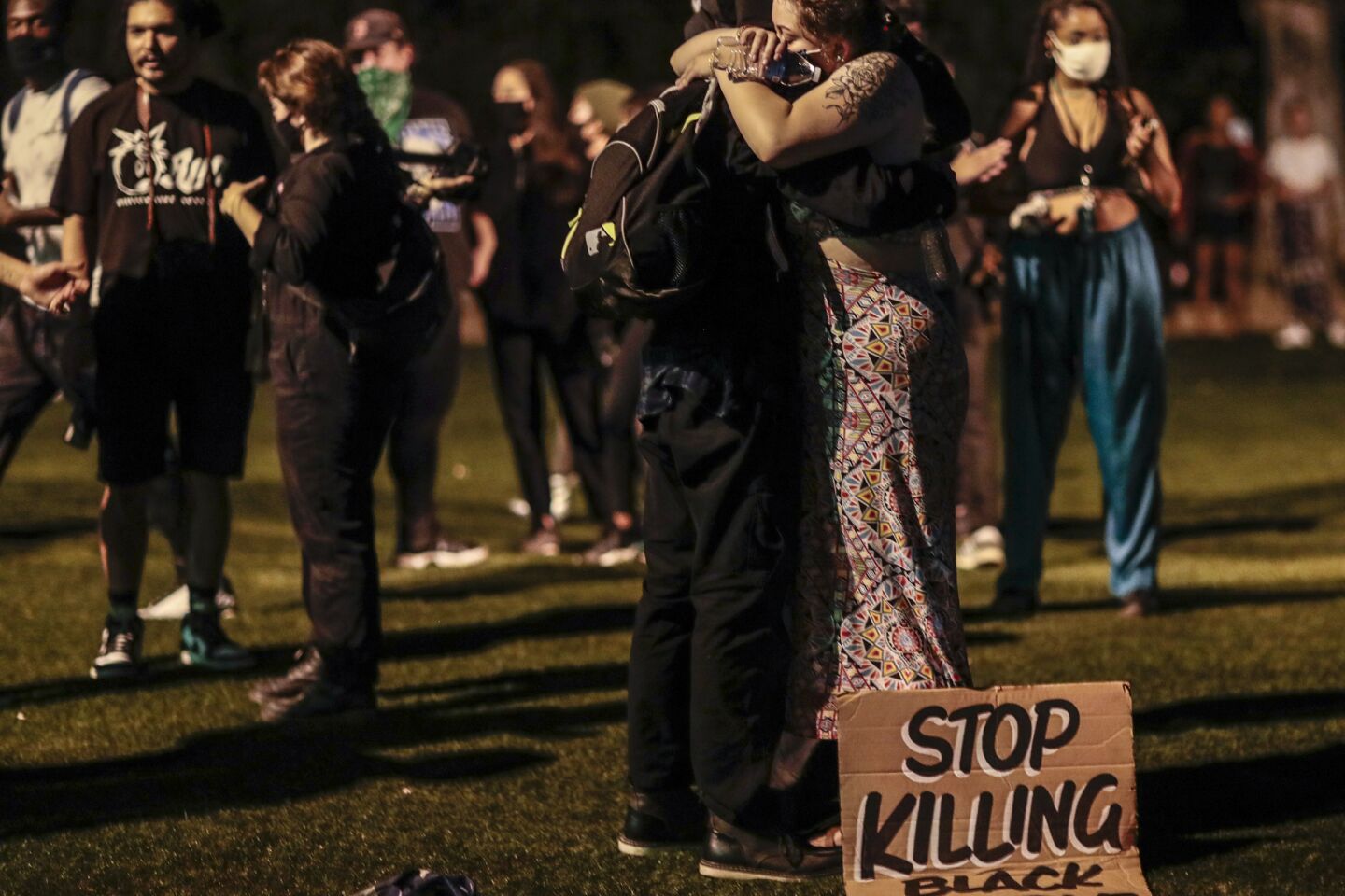 Protesters hug outside Hollywood Forever