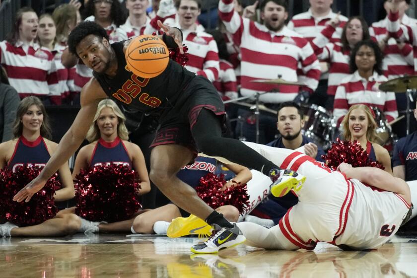 Southern California guard Bronny James (6) scrambles for the bal lwith Arizona guard Pelle Larsson (3) during the first half of an NCAA college basketball game in the quarterfinal round of the Pac-12 tournament Thursday, March 14, 2024, in Las Vegas. (AP Photo/John Locher)