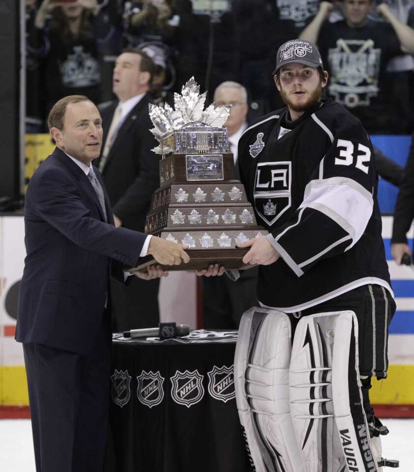 NHL Commissioner Gary Bettman presents Kings goaltender Jonathan Quick with the Conn Smythe Trophy, which goes to the most valuable player of the NHL playoffs.