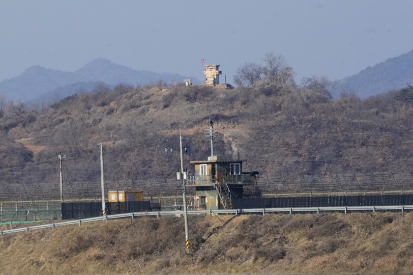 Military guard posts of North Korea, rear, and South Korea, front, are seen in Paju, near the border with North Korea, South Korea, Sunday, Jan. 2, 2022. South Korea's military said Sunday that an unidentified person crossed the heavily fortified border into North Korea. (AP Photo/Ahn Young-joon)