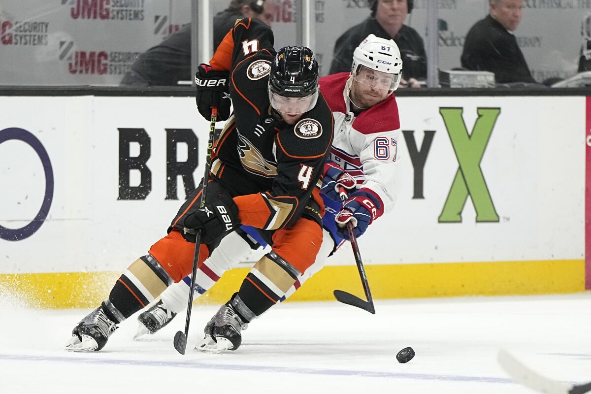 Ducks defenseman Cam Fowler, left, and Montreal Canadiens forward Chris Tierney battle for the puck.