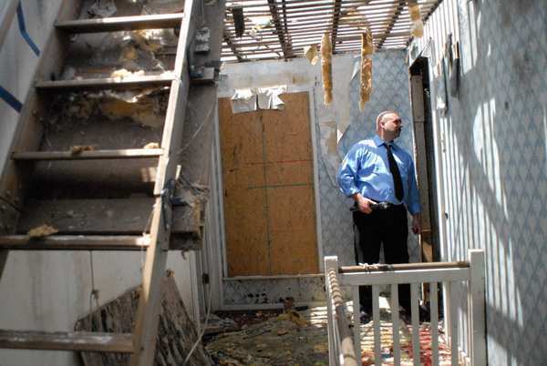 Joplin, Mo., native Walt "Ray" Goodman surveys what's left of his parents' home after a storm hit the community.