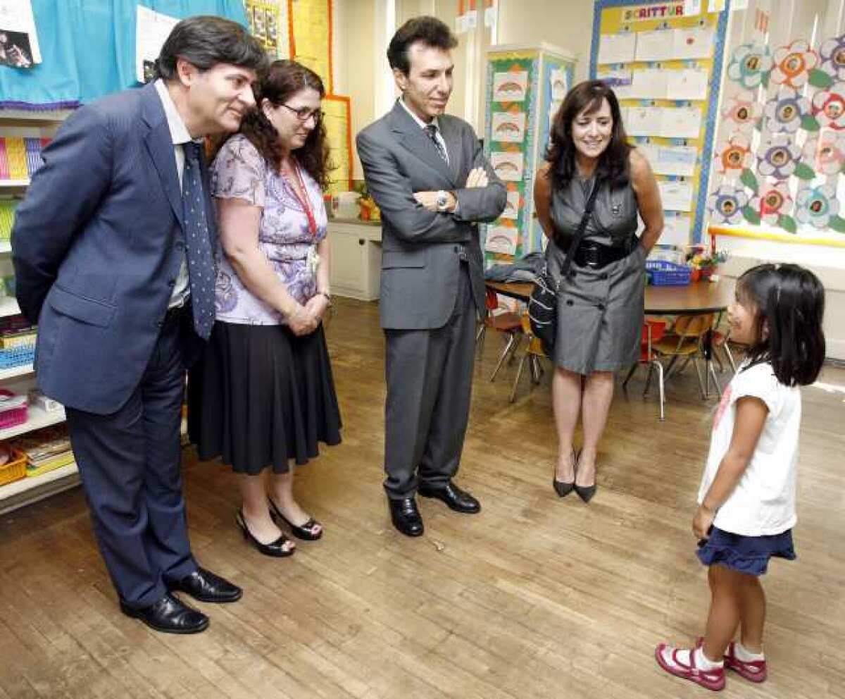 Franklin Elementary School kindergartener Emi Moses greets, from left, Italian Cultural Institute's Massimo Sarti, principal Vickie Atikian, Consul General of Italy Giuseppe Perrone and IFLAG Immersion Teacher Specialist Ana Jones during visit to the Italian Immersion Kindergarten Class at the Glendale school.