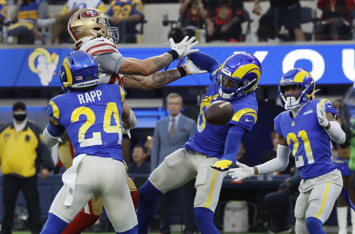 Rams cornerback Jalen Ramsey (5) reaches out to intercept a deflected pass intended for 49ers tight end George Kittle (85).