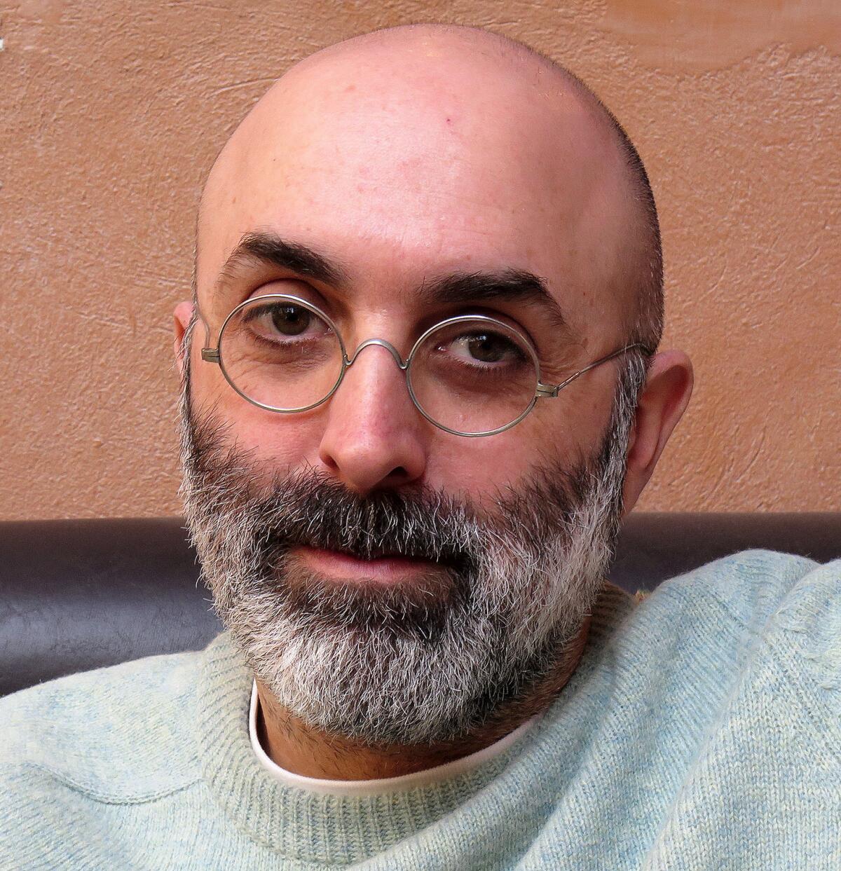 A man with a beard and glasses.