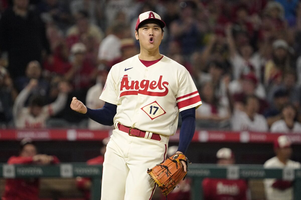 Angels' Shohei Ohtani celebrates after striking out Oakland Athletics' Vimael Machin.
