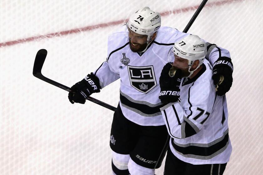 Jeff Carter and Dwight King celebrate a goal on June 9.