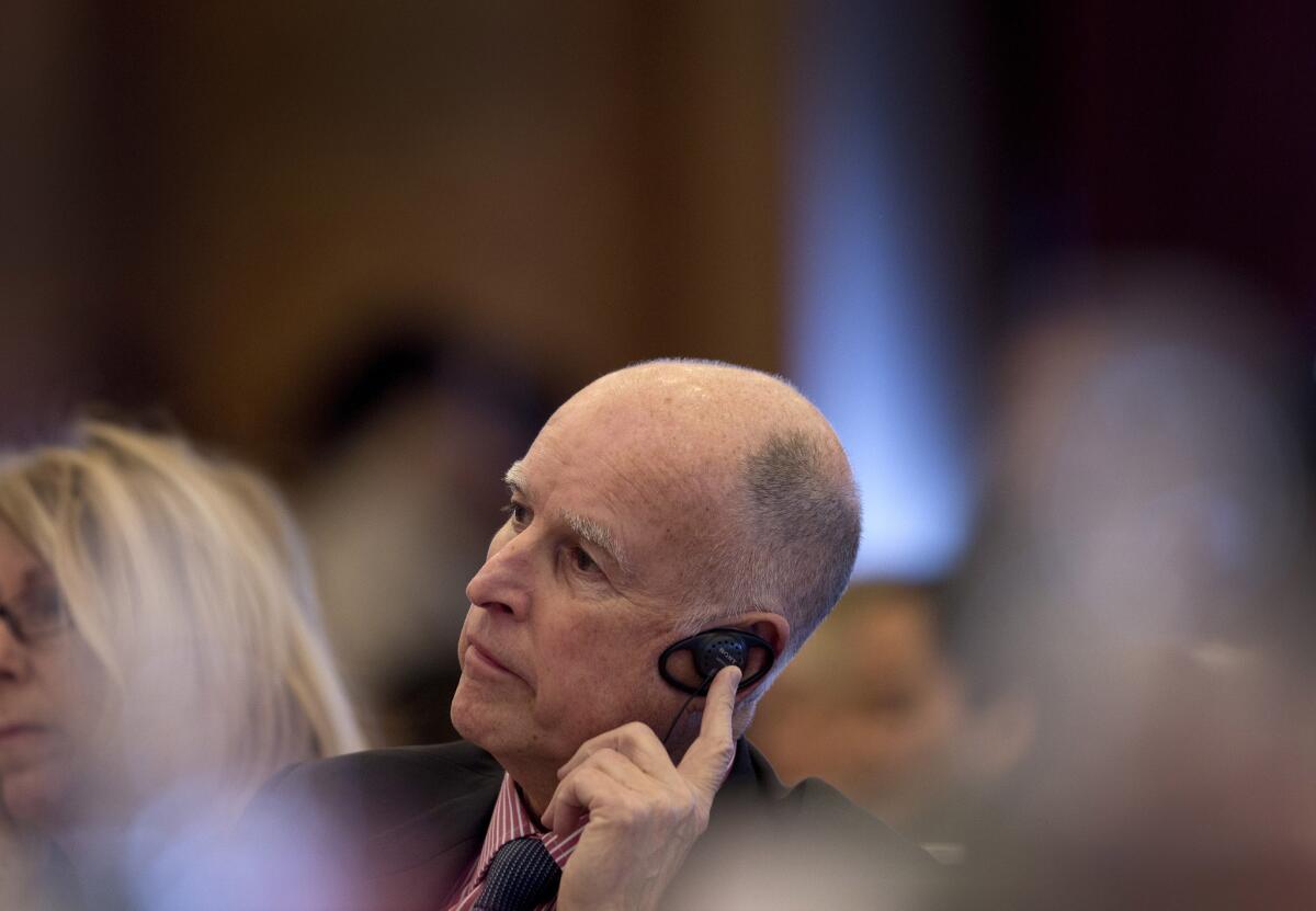 California Gov. Jerry Brown listens during a session on energy innovation and low-carbon development at Tsinghua University in Beijing.