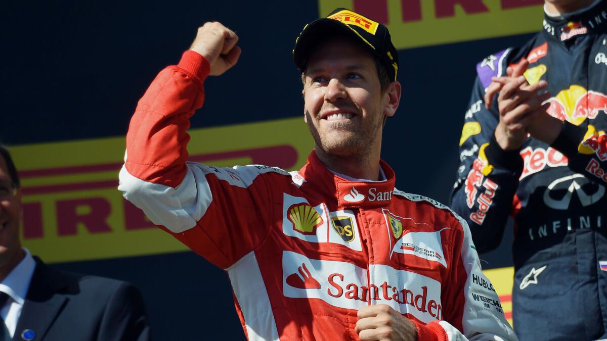 Ferrari driver Sebastian Vettel celebrates on the podium after winning the Hungarian Grand Prix on Sunday.