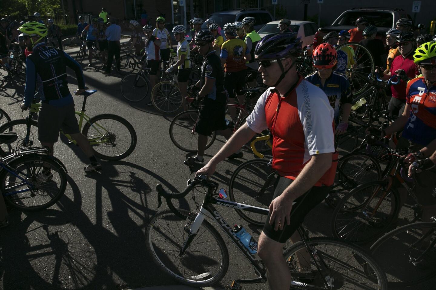 People prepare for a silent bike ride in Kalamazoo, Mich., on June 8, 2016, supporting the cyclists who were killed and injured in a crash the day before.